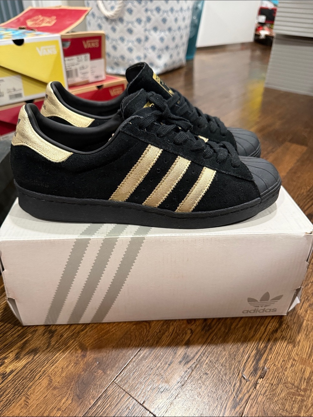 adidas Black Suede Superstar Sneakers with Gold Stripes